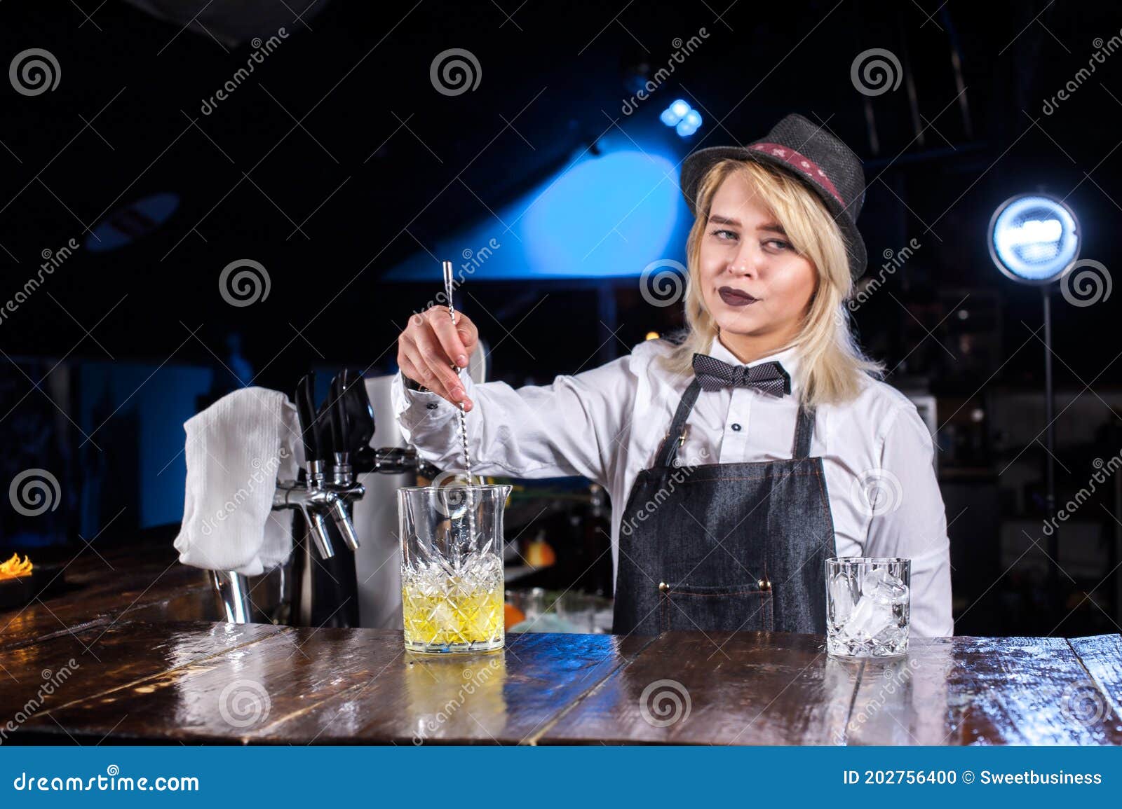 Expert Girl Bartender Decorates Colorful Concoction on the Bar Stock ...