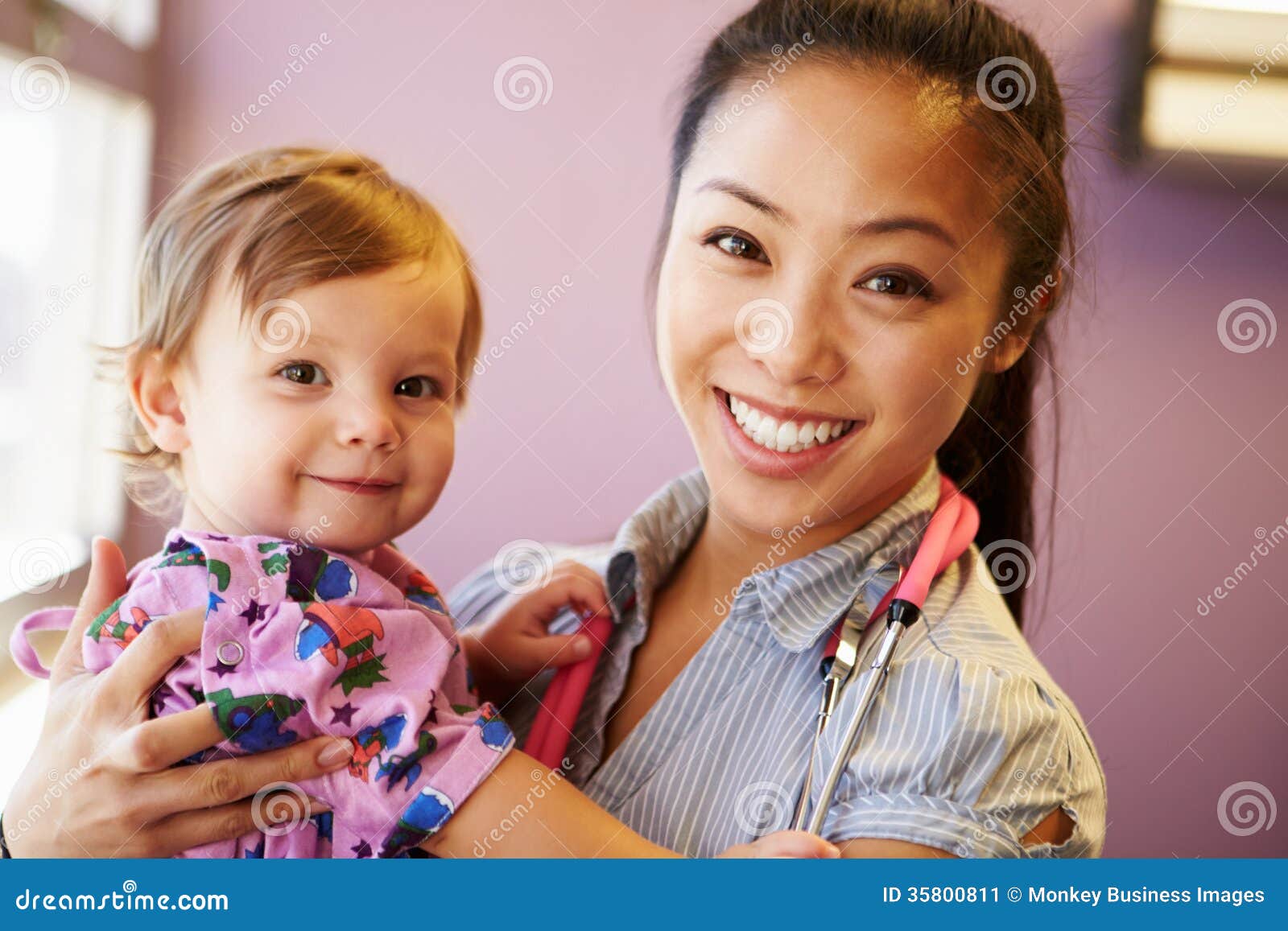 young girl being held by female pediatric doctor