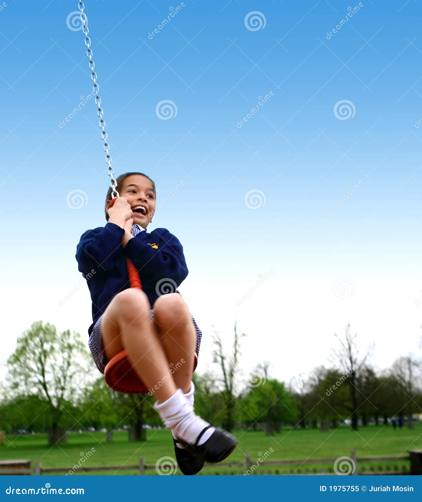 a young girl being pulled on a mono swing