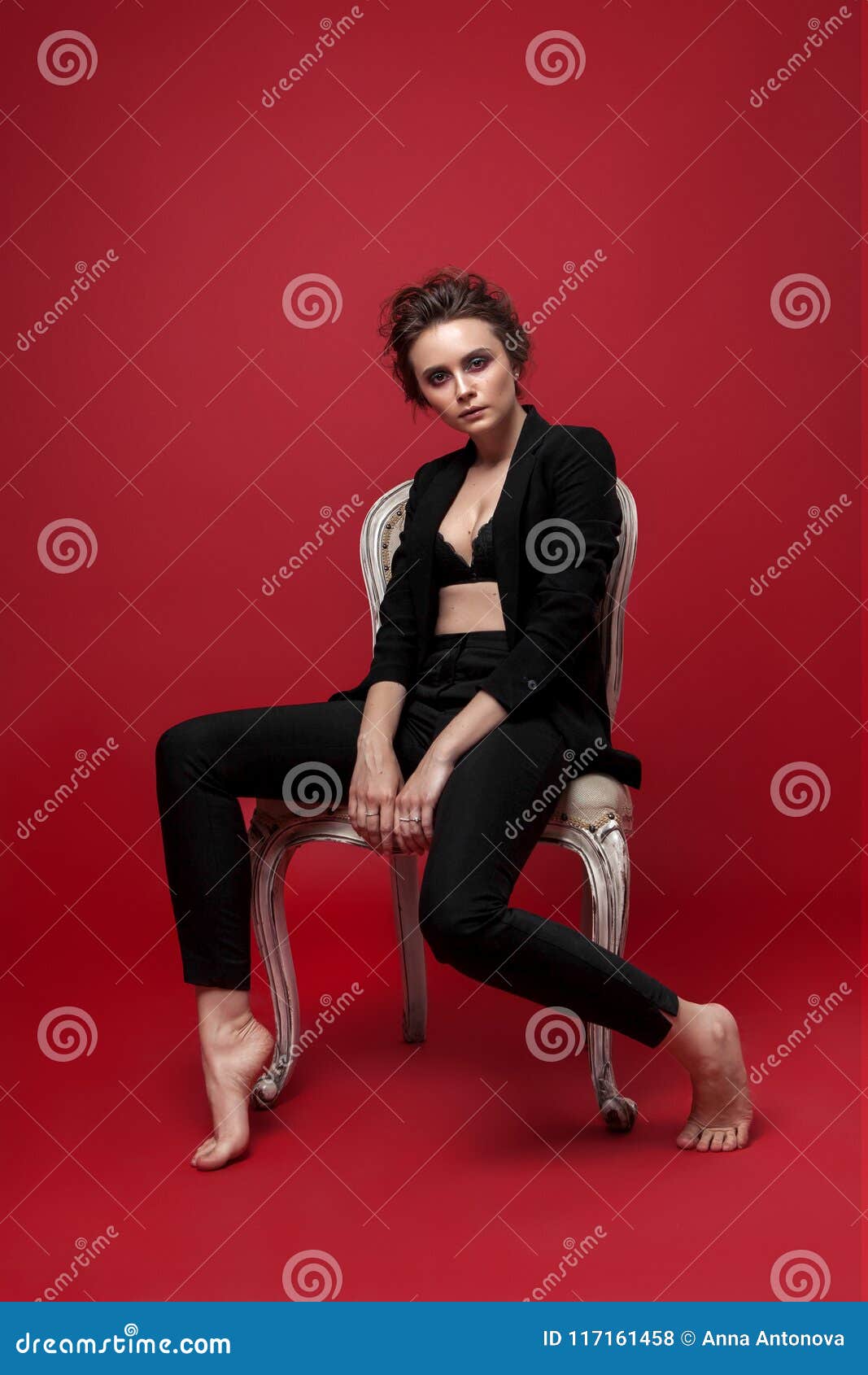 Portrait of Young Girl in Black Suit on Red Background Sitting Pose Stock  Photo - Image of natural, studio: 117161458