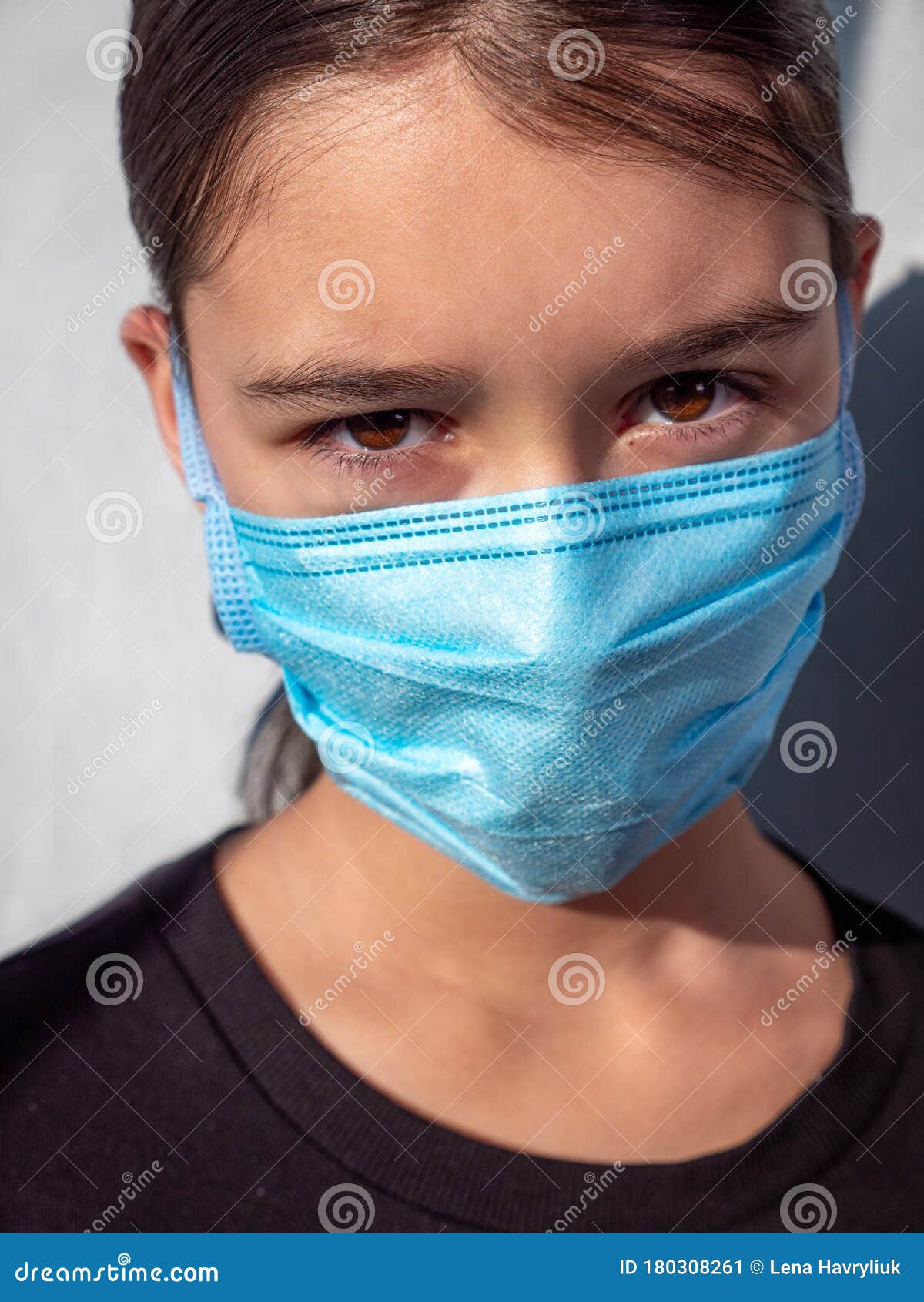 Young Girl in a Blue Medical Facemask To Protect Herself from ...