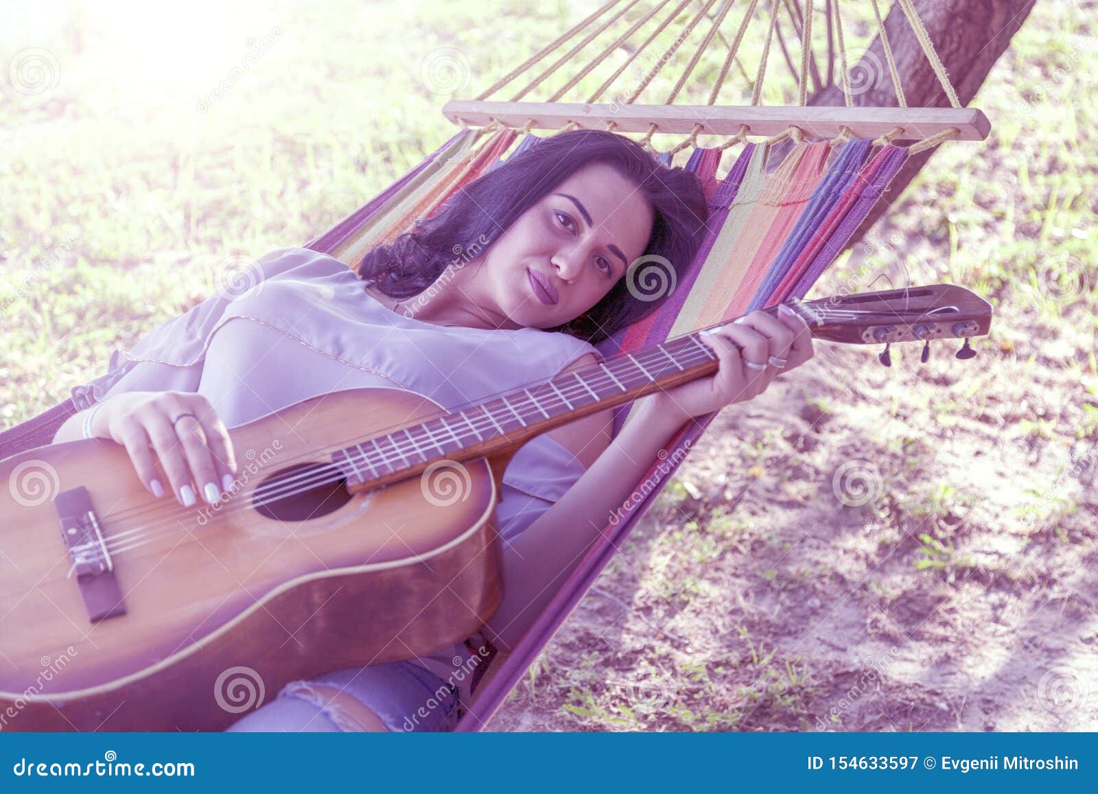 Young Girl Brunette Lies In A Hammock With A Guitar Toned Stock Image Image Of Guitar