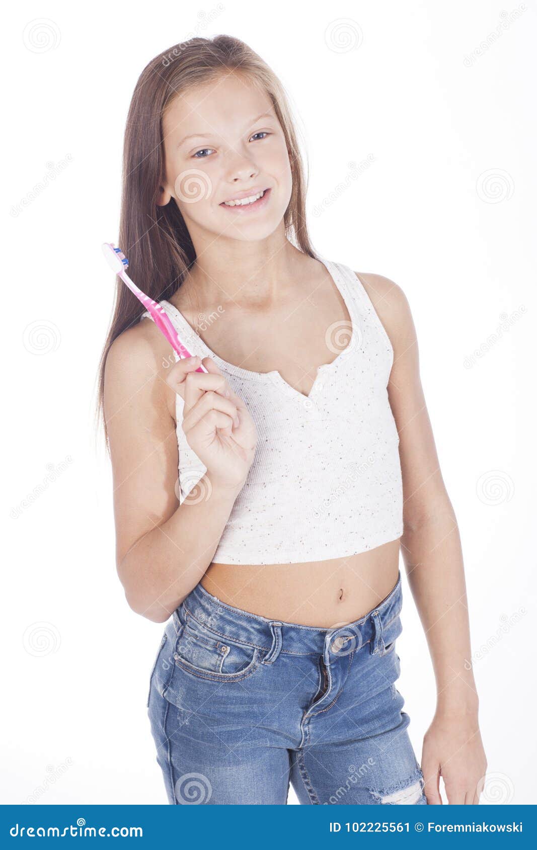 young girl is brushing her teeth.