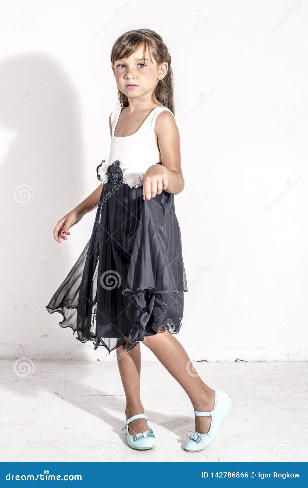 Young Girl Child in a Black and White Festive Dress with Brunettte Hair ...