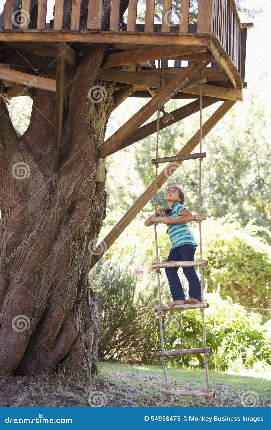 Young Girl Climbing Rope Ladder To Treehouse Stock Image - Image