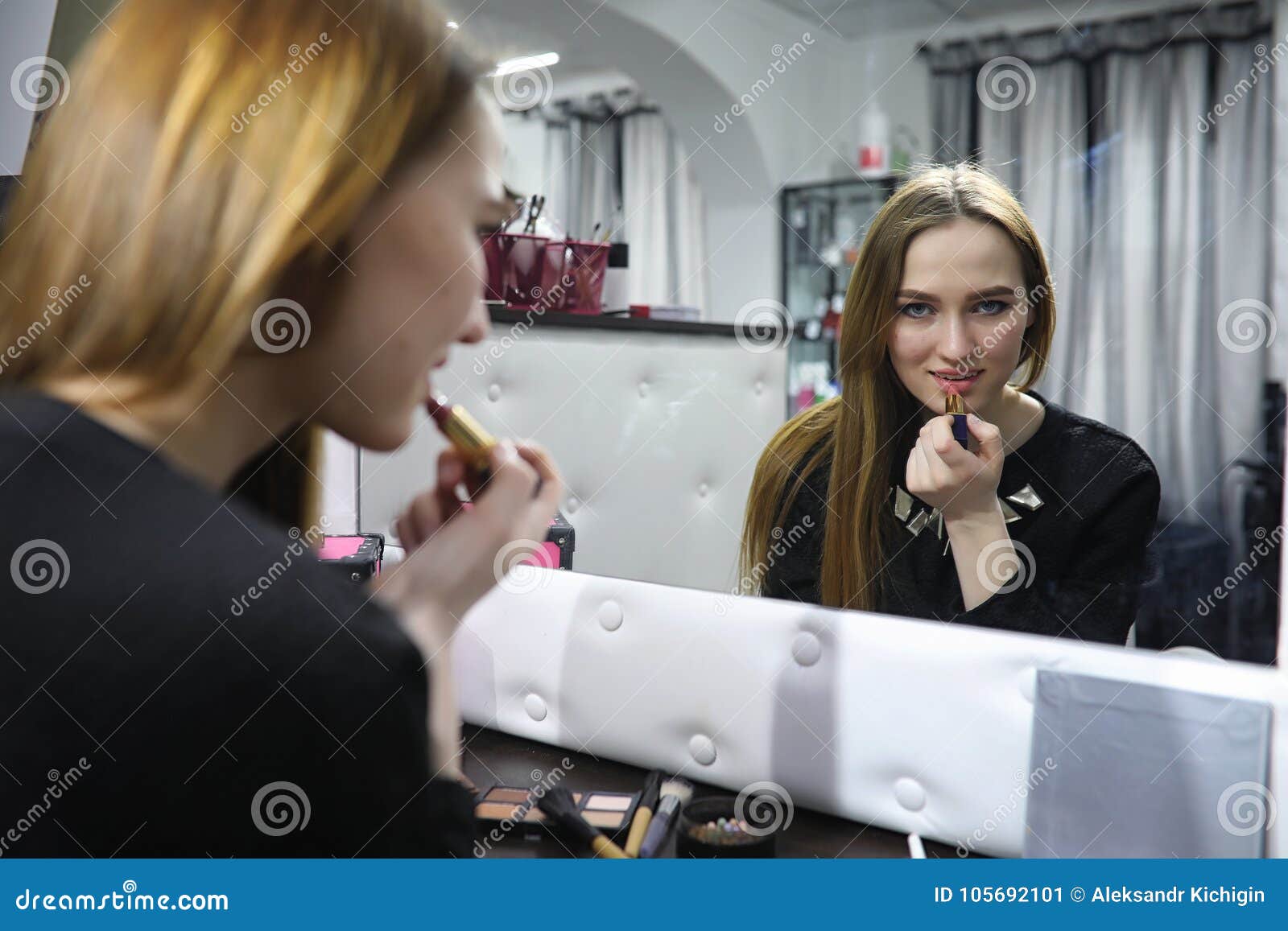 A Young Girl Does Make-up in a Beauty Salon. the Girl in Front O Stock ...