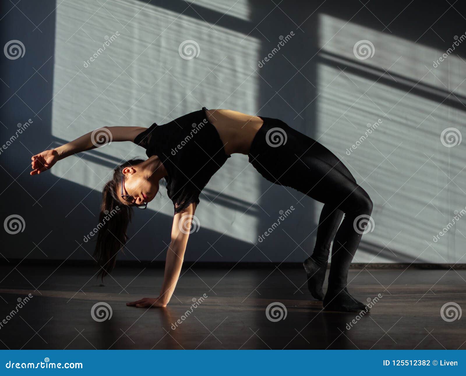 A Young Girl is Doing Stretching in the Dance Hall. Stock Photo - Image ...