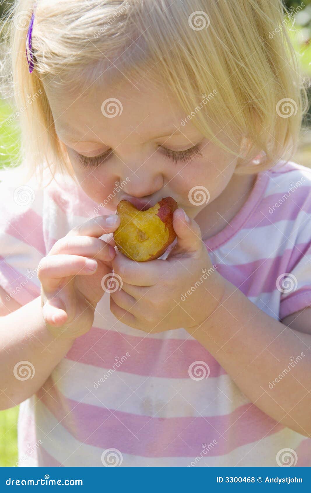 Young girl eating a plum stock photo. Image of girl, blond 3300468