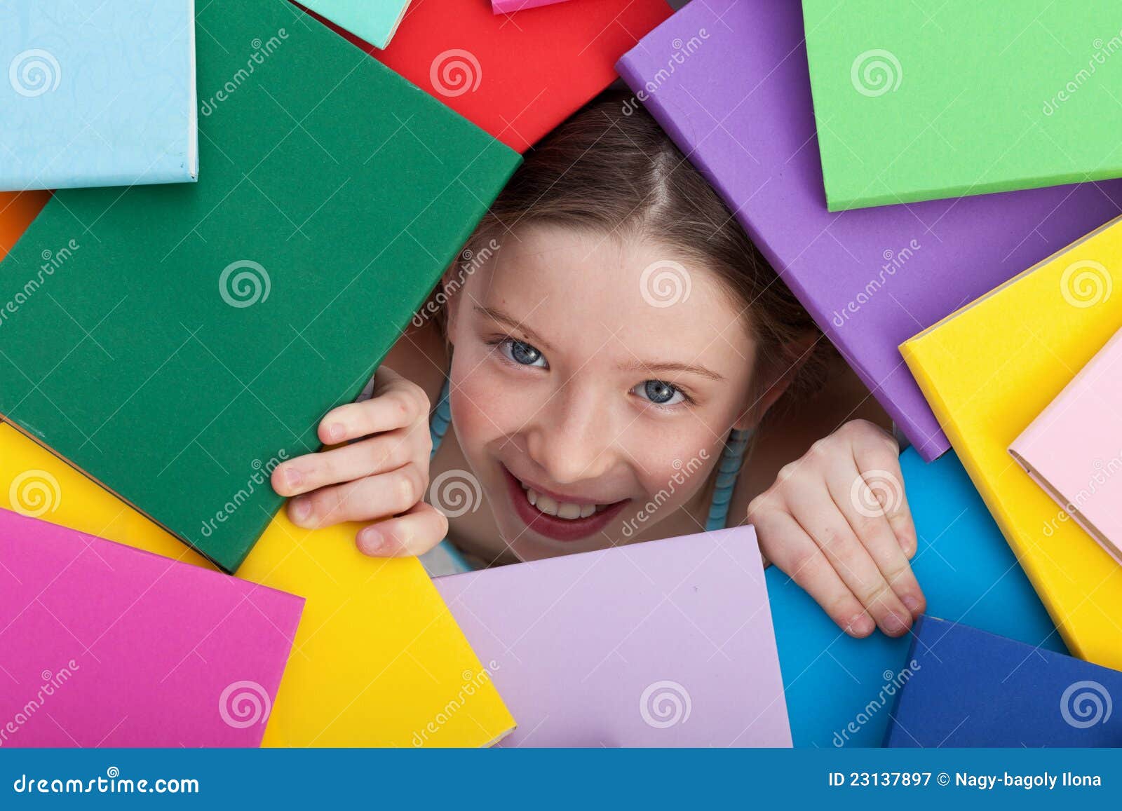 young girl emerging from beneath books