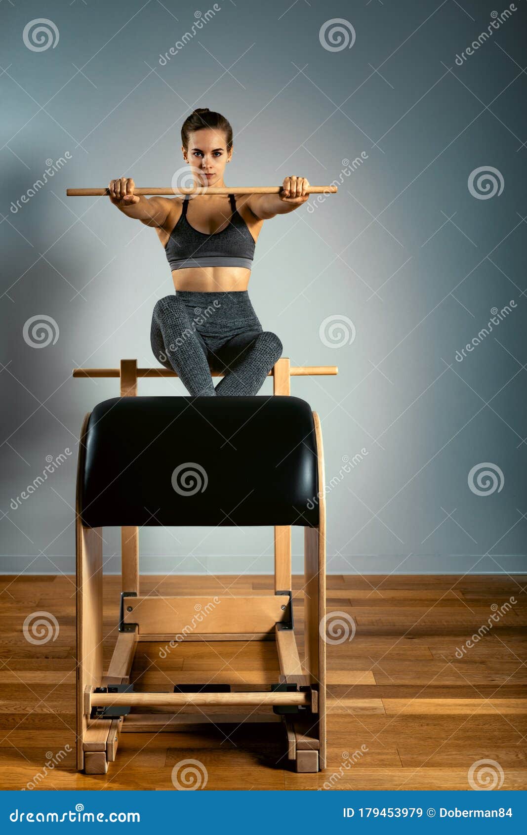 Young Girl Exercises on a Bed of Pilates Reformers, in the Hall on a ...