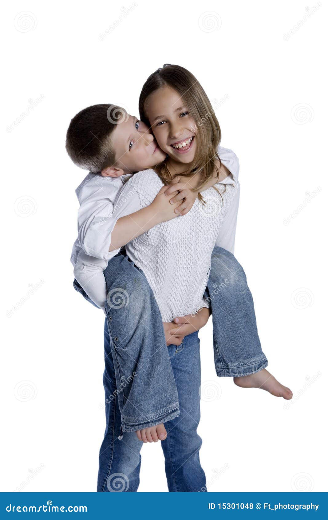 Young girl carrying sister giving piggyback ride Stock Photo