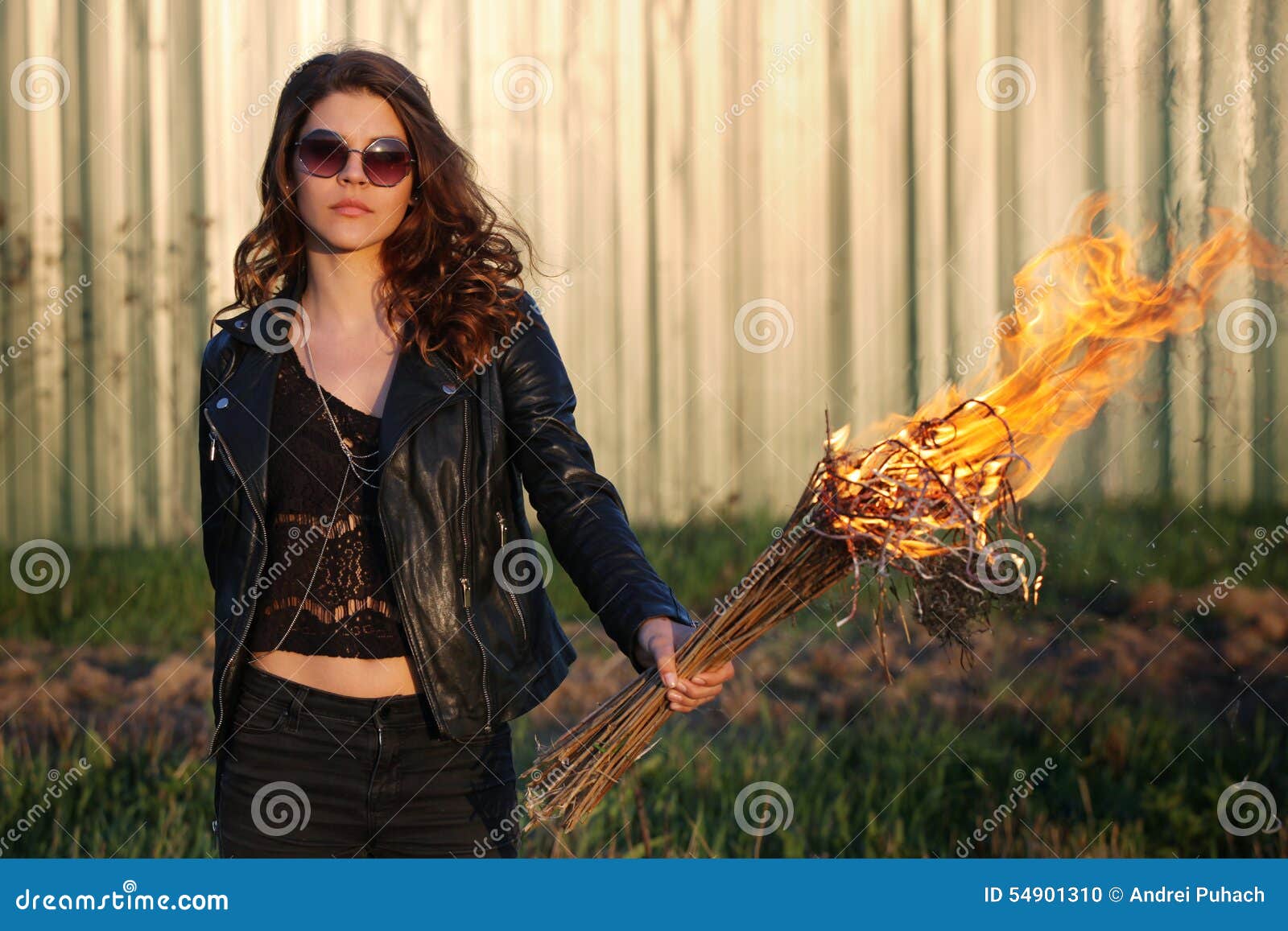 Young Girl with Glasses and a Bully Black Jacket Holding the Torch