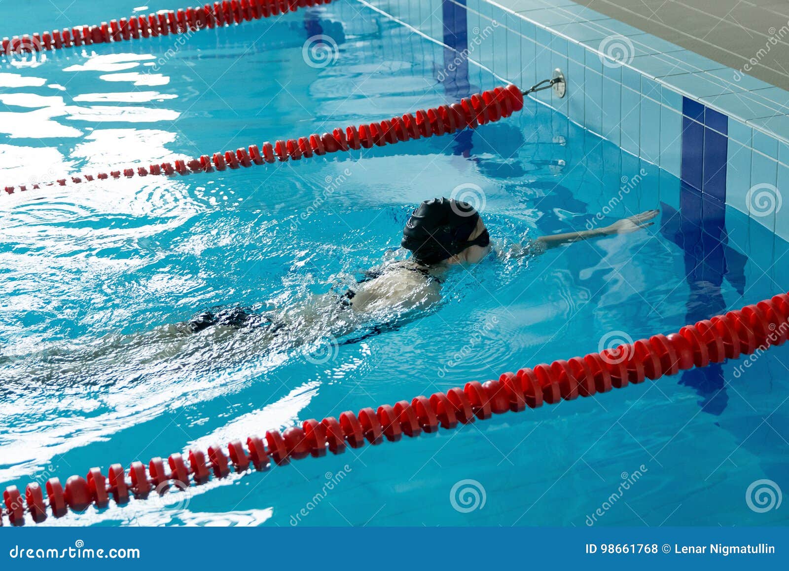 Young Girl in Goggles and Cap Swimming Crawl Stroke Style in the Blue ...