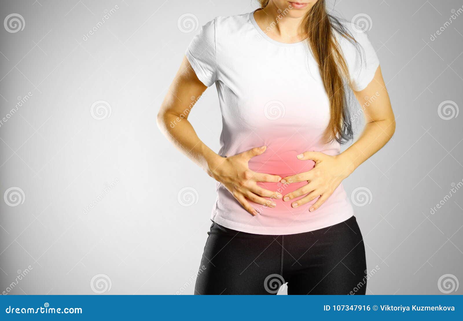 the young girl has a stomach ache. pain in the abdomen. the pain