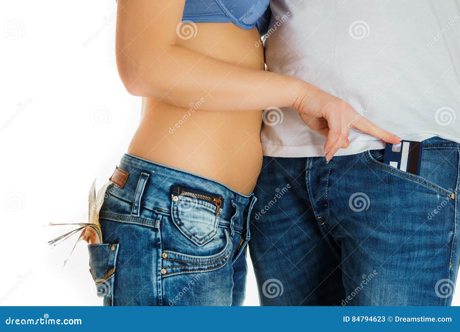 Young girl in jeans and a naked stomach stealing a credit card from man