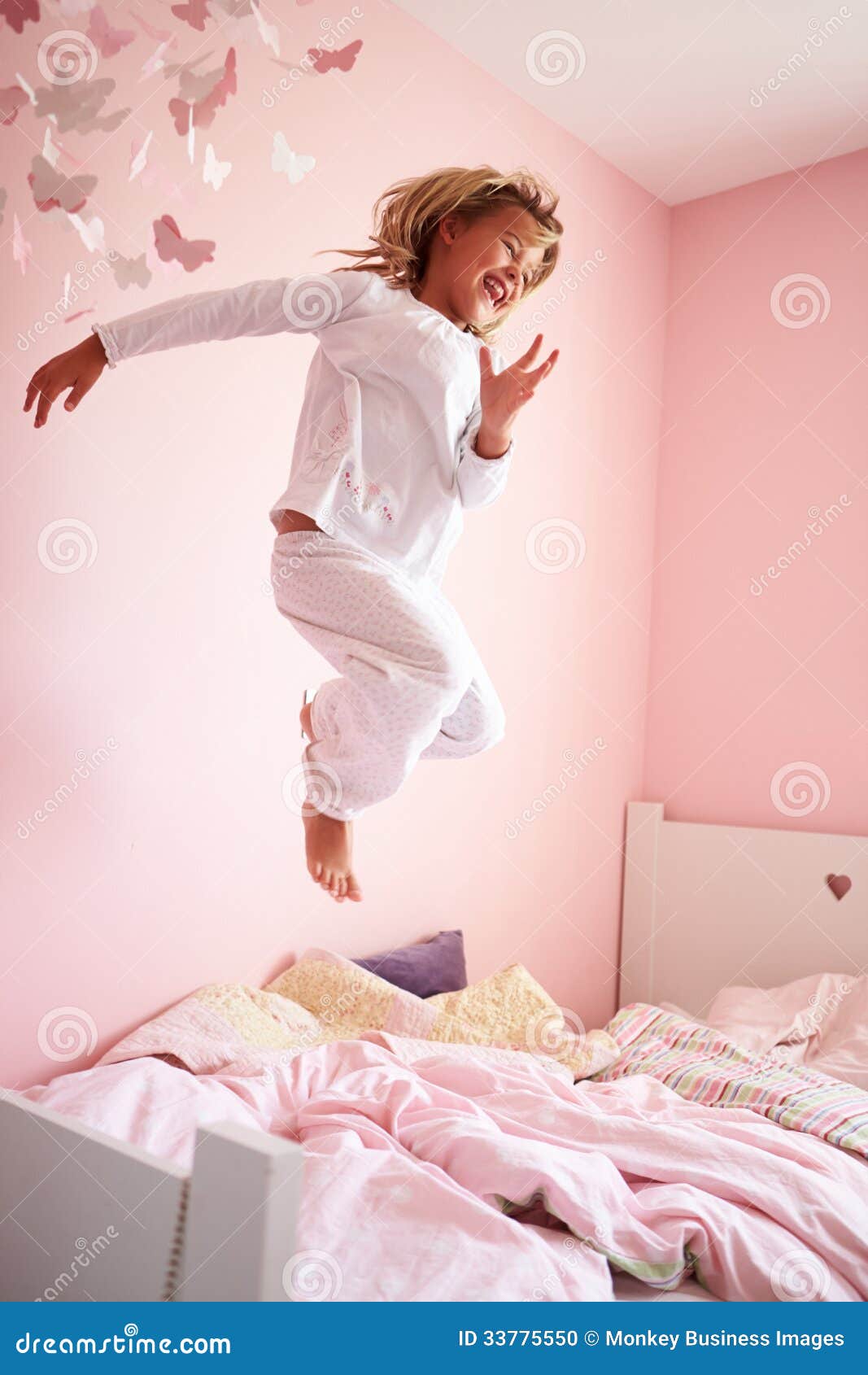 Young Girl Jumping on Her Bed Stock Photo Image of children, home