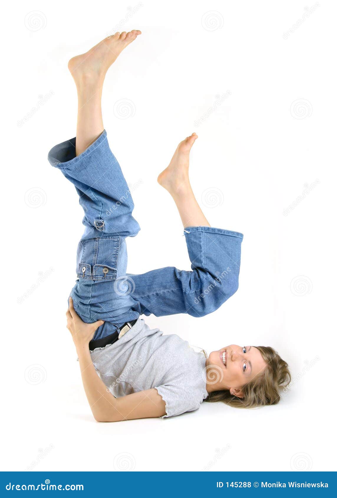 Young Woman Doing The Splits At Home With Her Leg Up On 