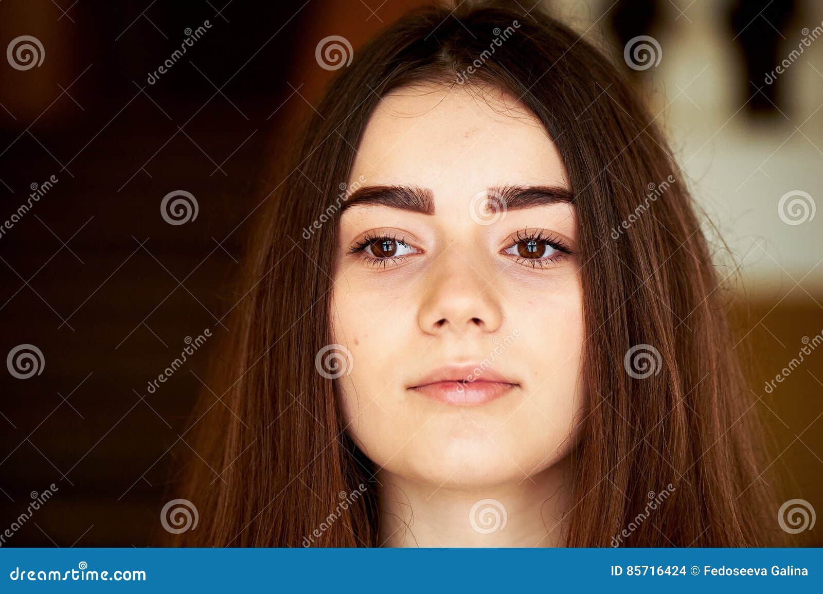 Young Girl Looking At The Camera Long Dark Hair And Brown