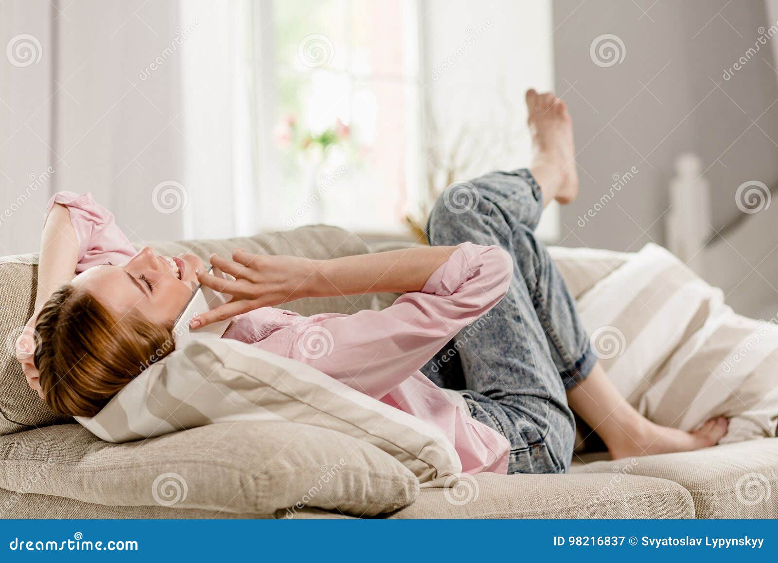 Young Girl Lying Sofa Talking on Cell Phone. Stock Image - Image of ...