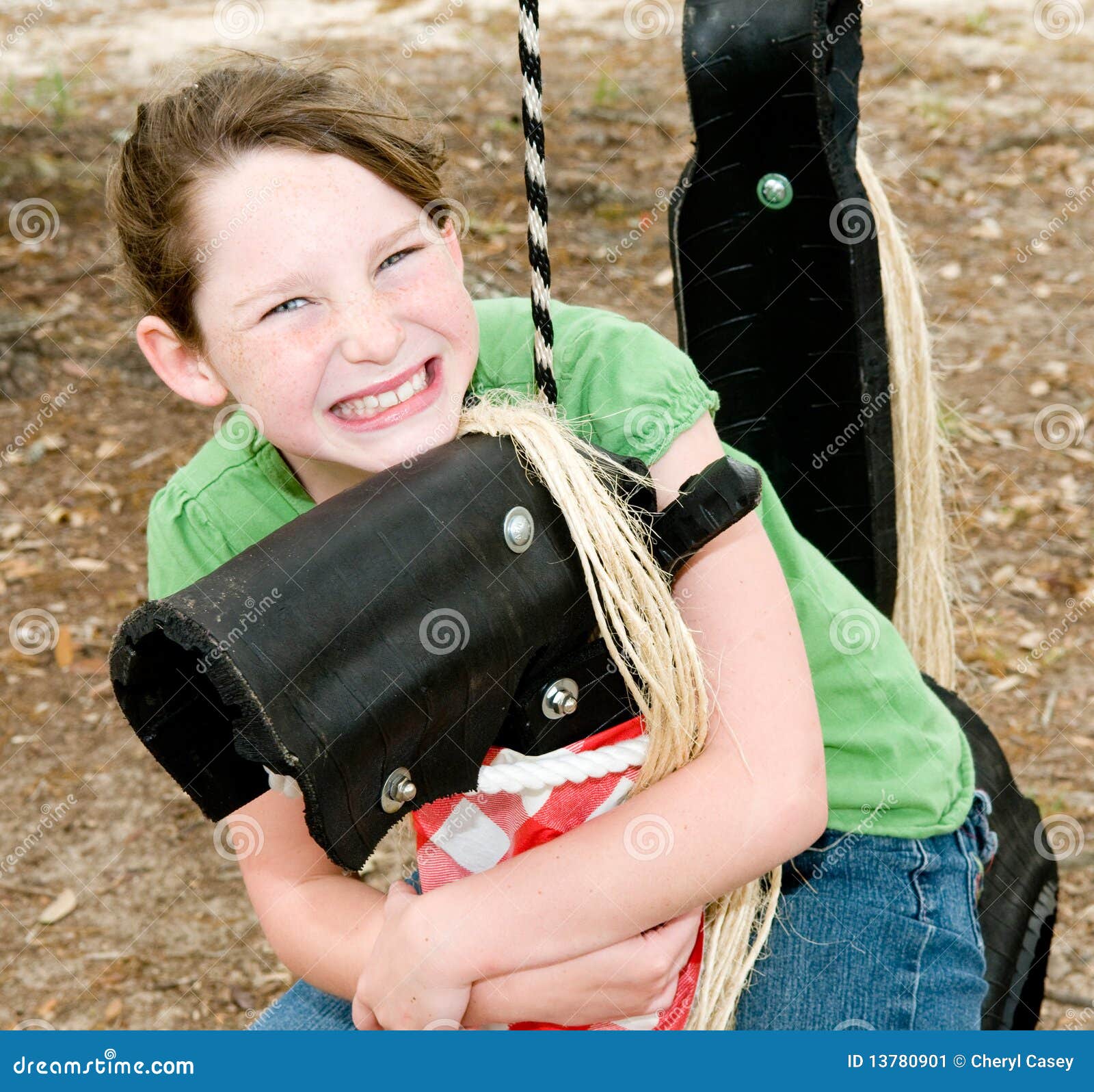 Young girl on play horse stock image. Image of swingset 13780901