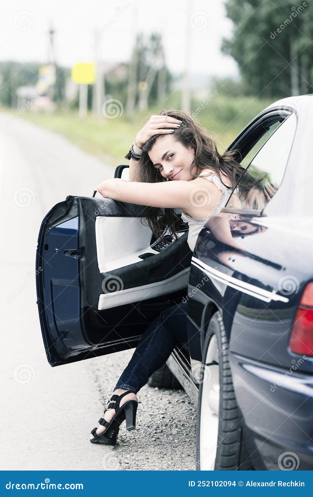 A Young, Girl Sitting in the Trunk of the Car. Stock Photo - Image of  pretty, accessories: 135599730