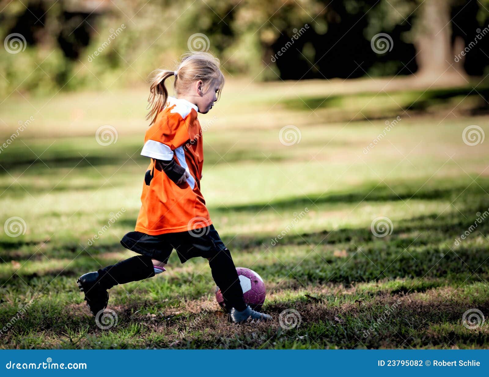 Young girl playing soccer stock photo. Image of field 23795082