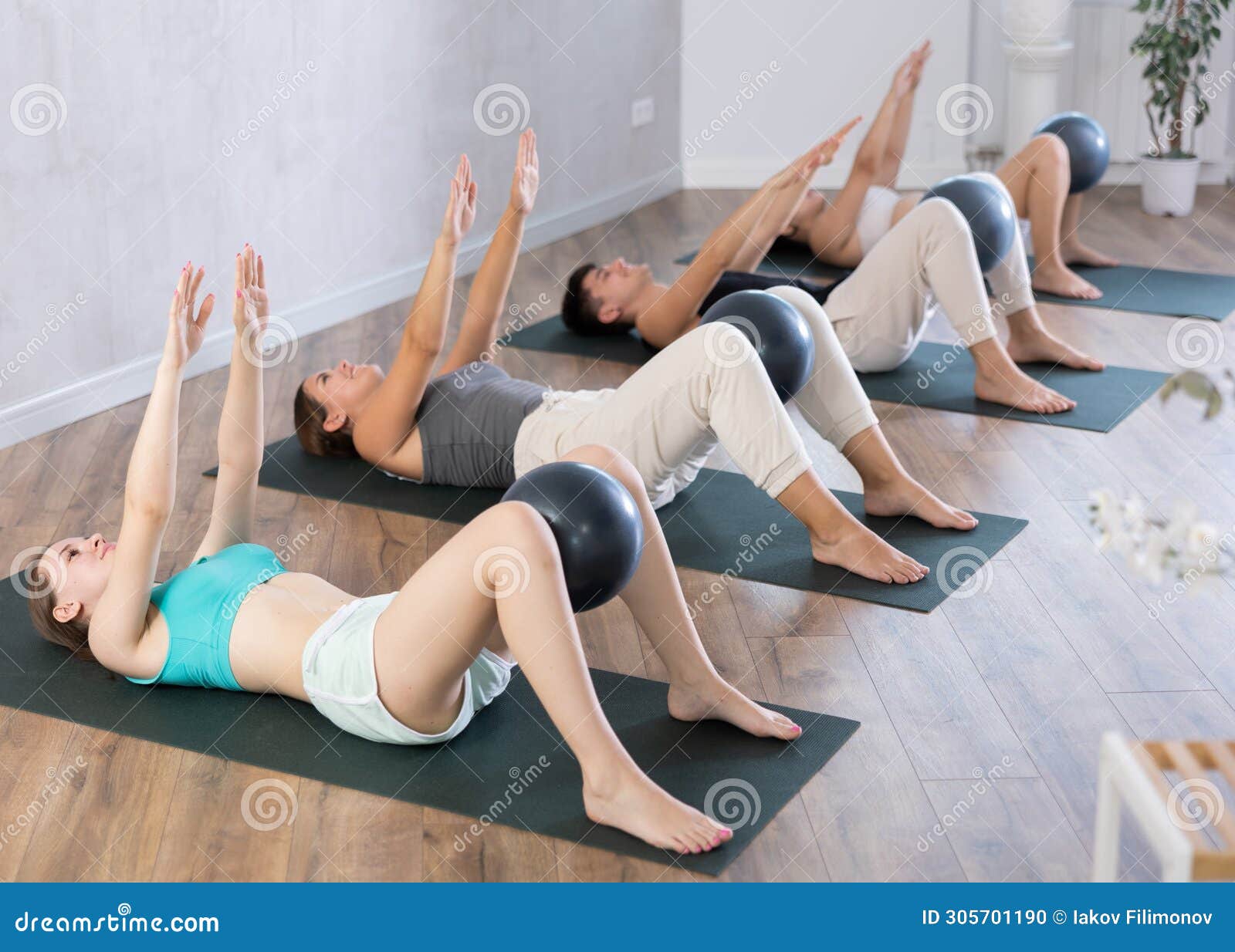 Young Girl Practicing Pilates Pose with Softball between Legs in Training  Area Stock Photo - Image of room, light: 305701190