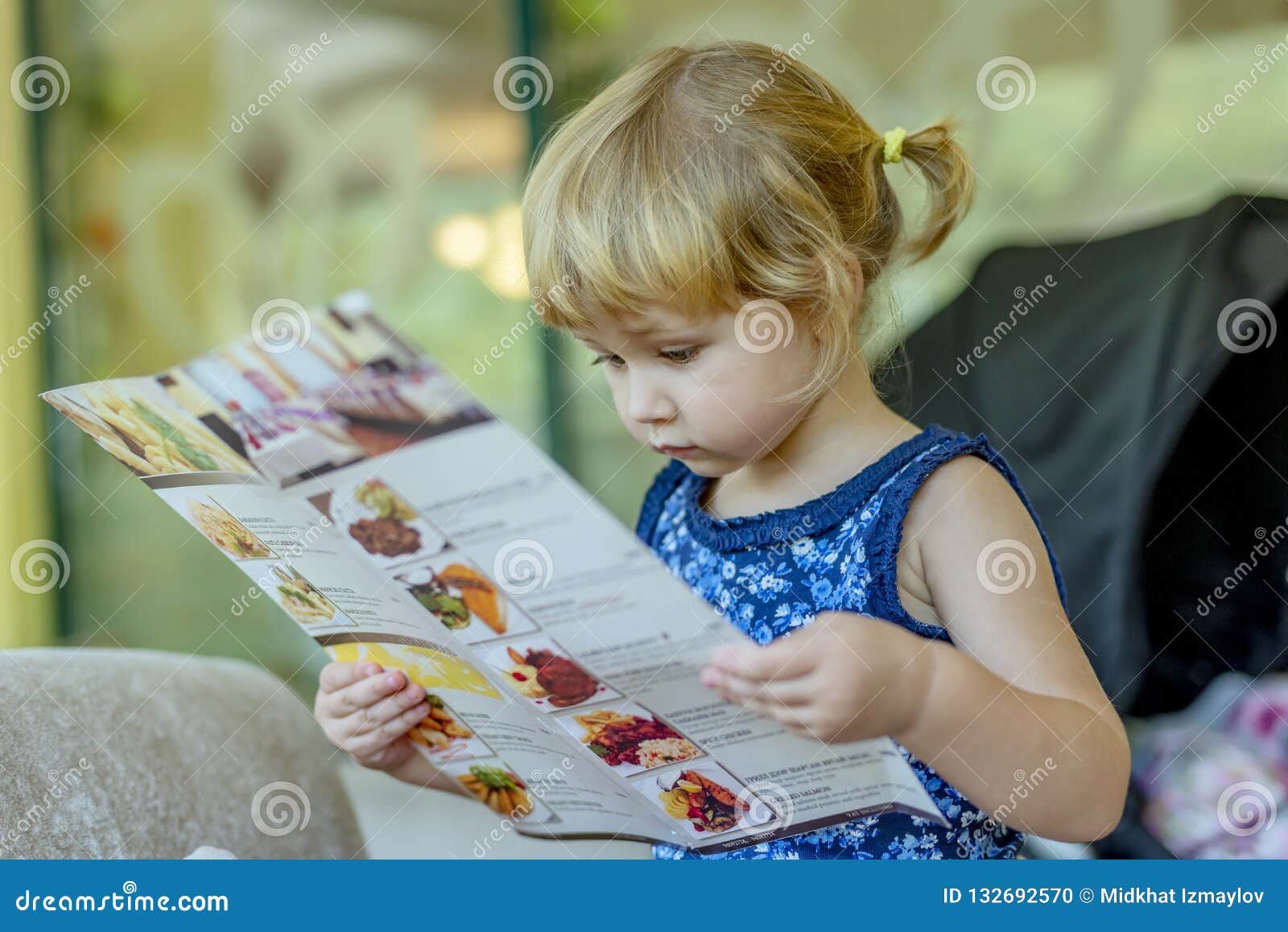 young girl reading menu