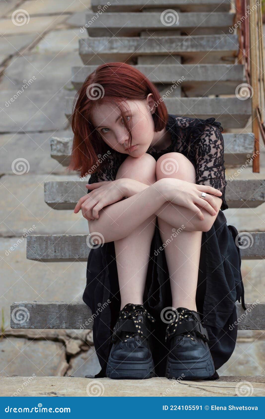 A Young Girl with Red Hair, in a Black Lace Dress, with a Piercing ...