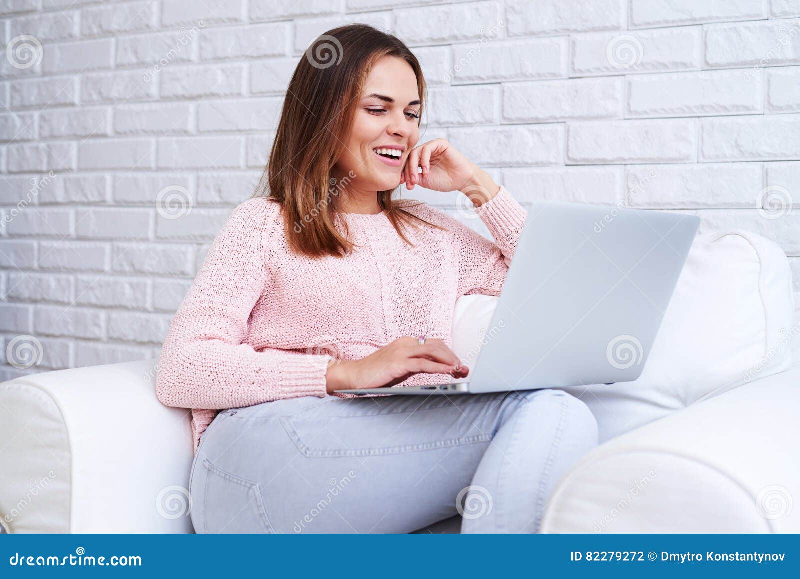Young Girl Sitting in an Armchair and Using a Laptop Isolated Over ...