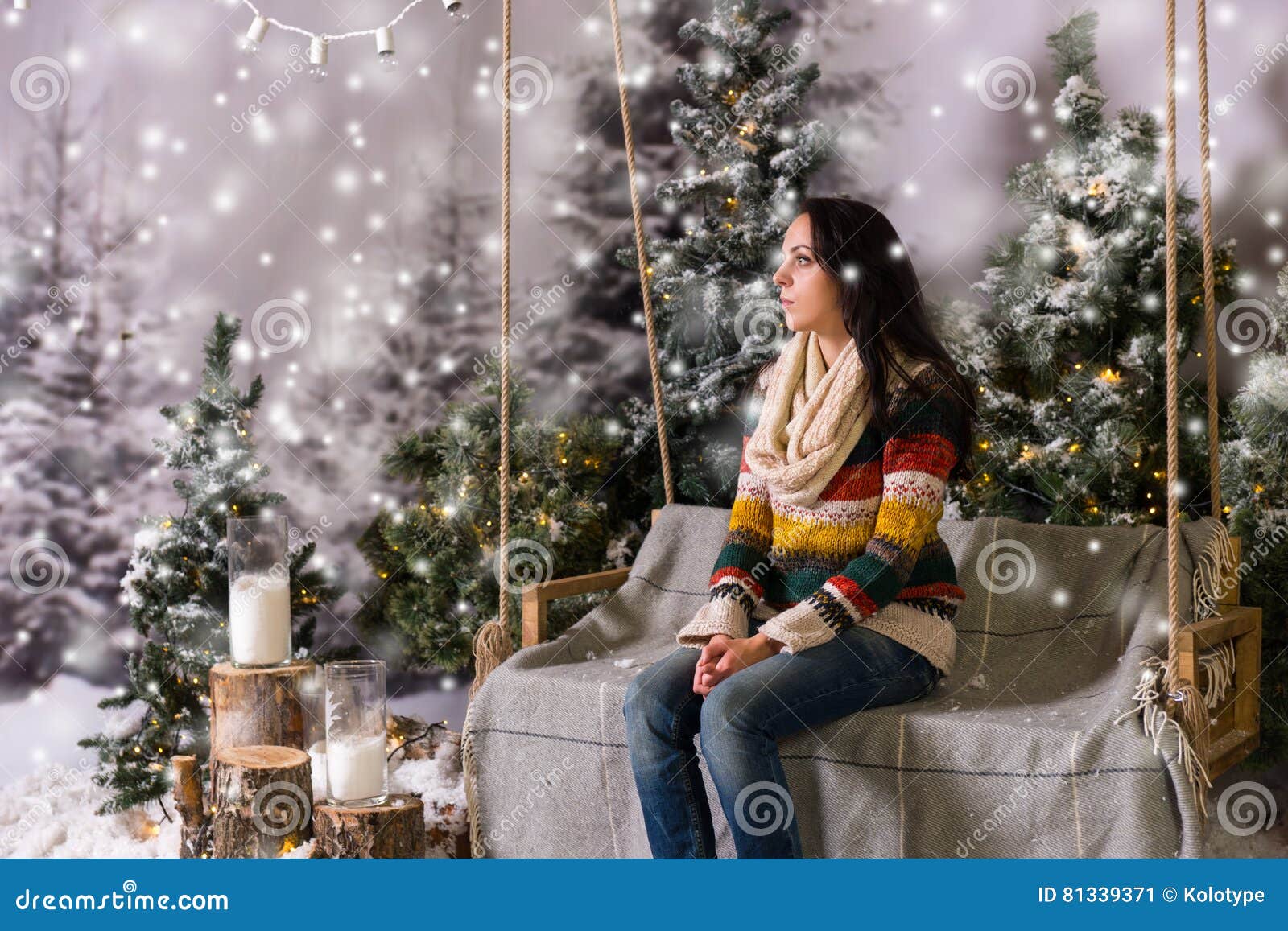 Young Girl Sitting on a Bench or a Swing in a Snow-covered Park Stock ...