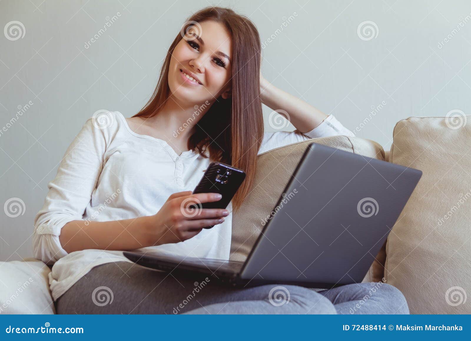 Young Girl Sitting on the Couch with a Laptop Stock Photo - Image of ...