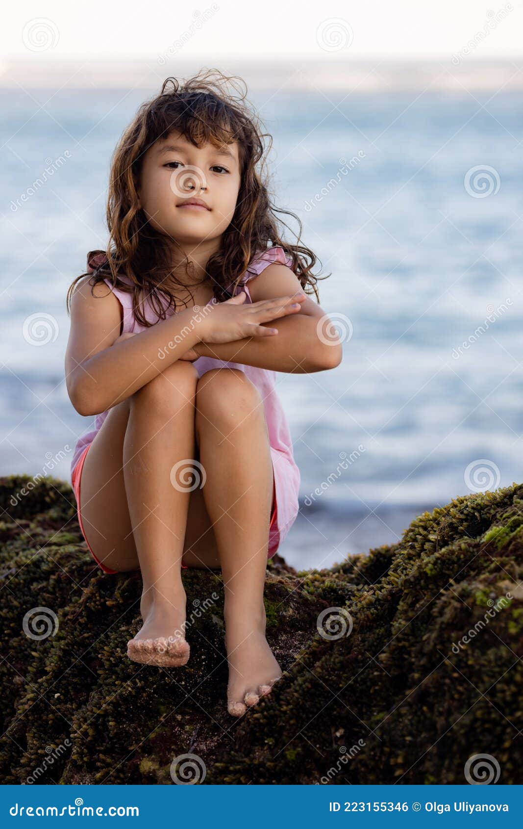 Young Girl Sitting on the Rock Near the Ocean and Smiling. Happy ...