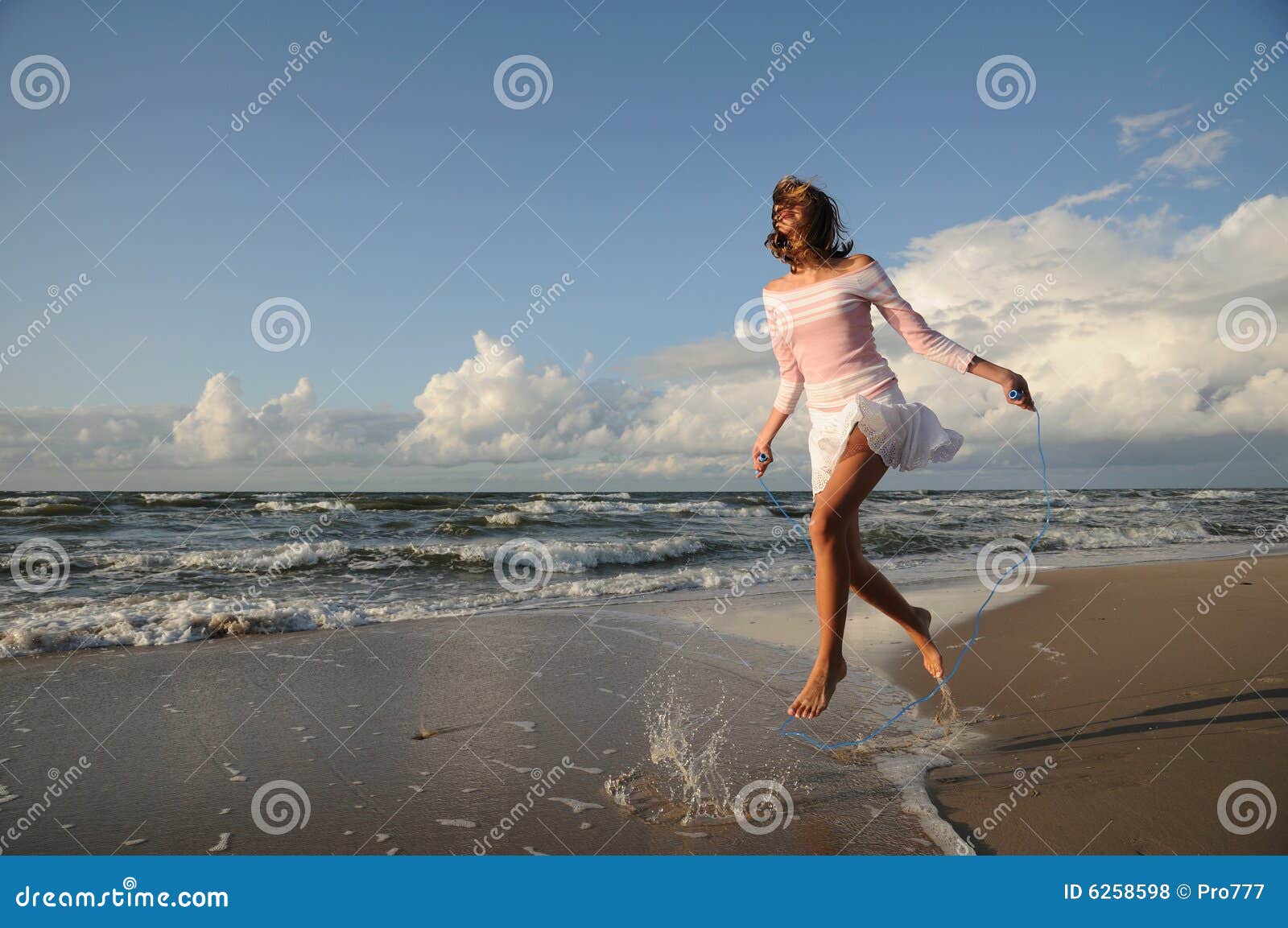 Young Girl Skipping on the Beach Stock Photo Image of cheerful