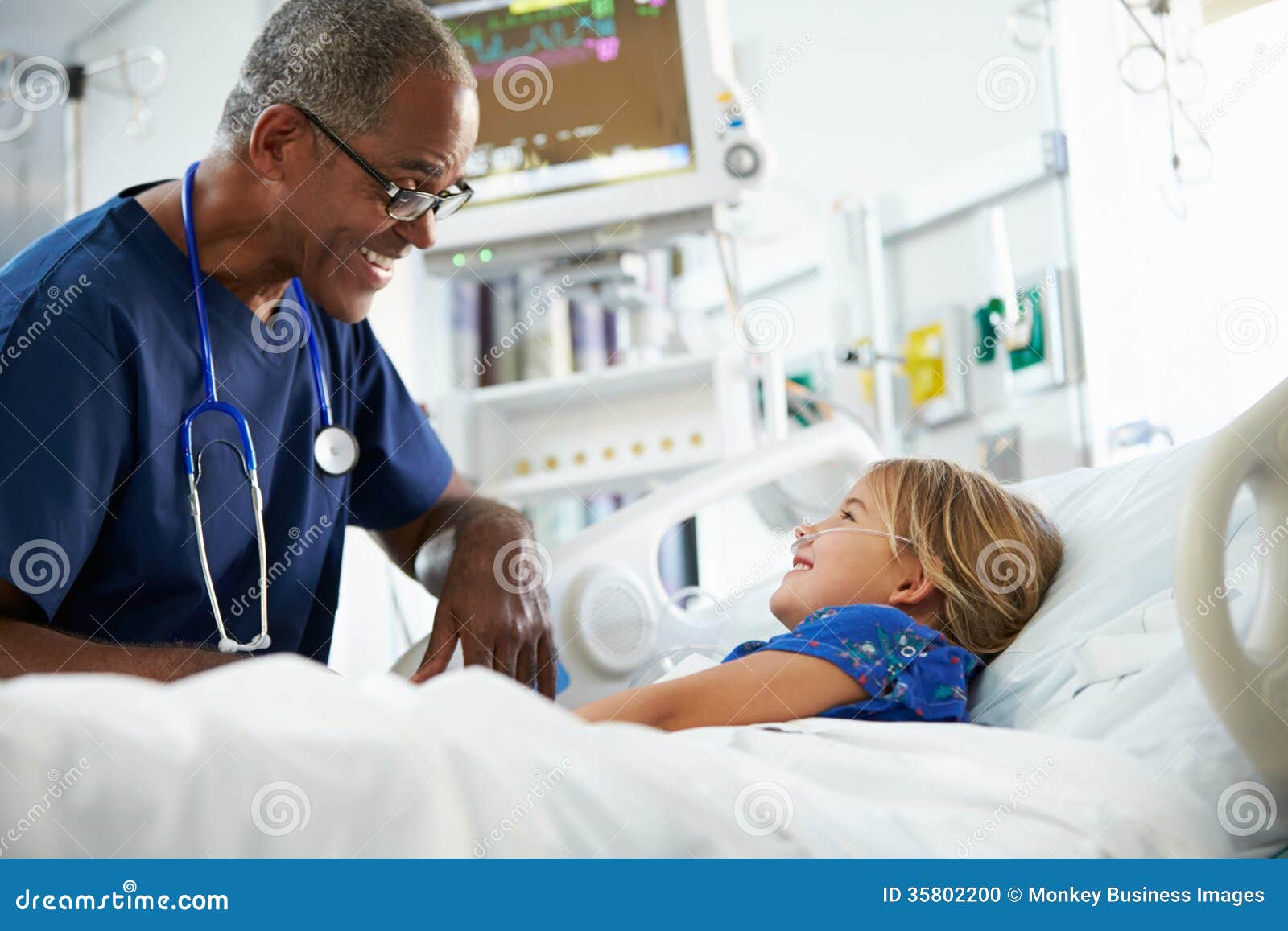 young girl talking to male nurse in intensive care unit