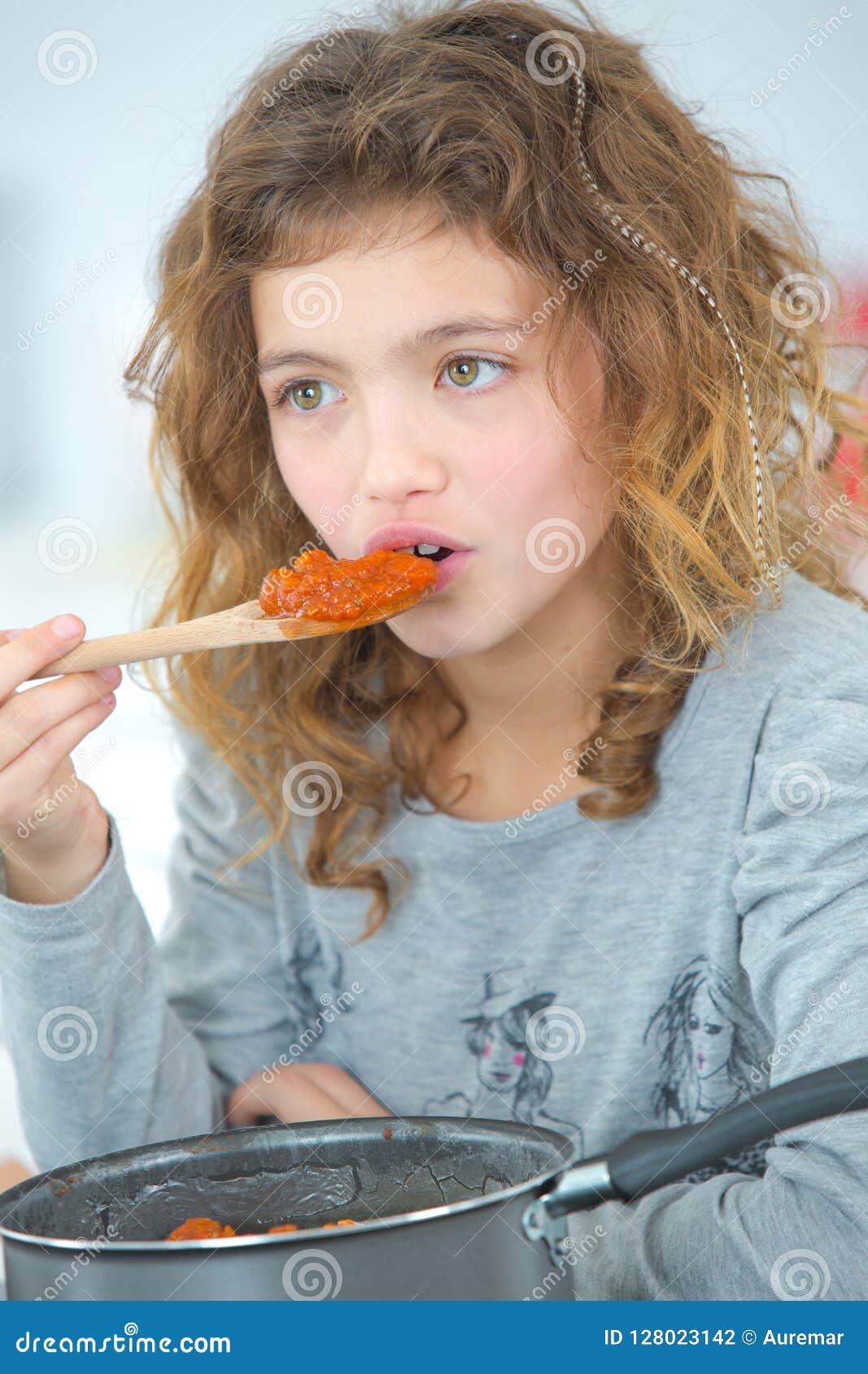 Young Girl Testing Food from Spoon Stock Photo Image of preparation