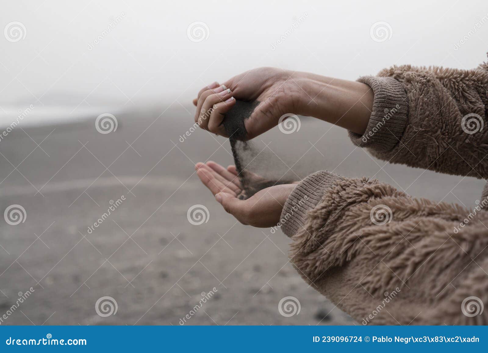 young girl throwing sand.