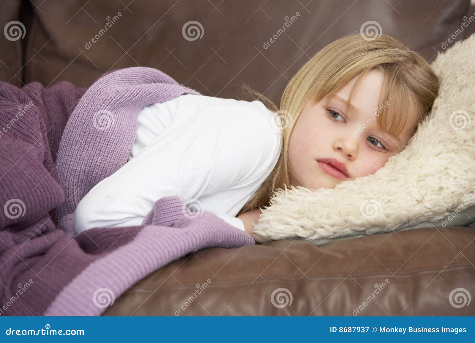 young girl unwell lying on sofa