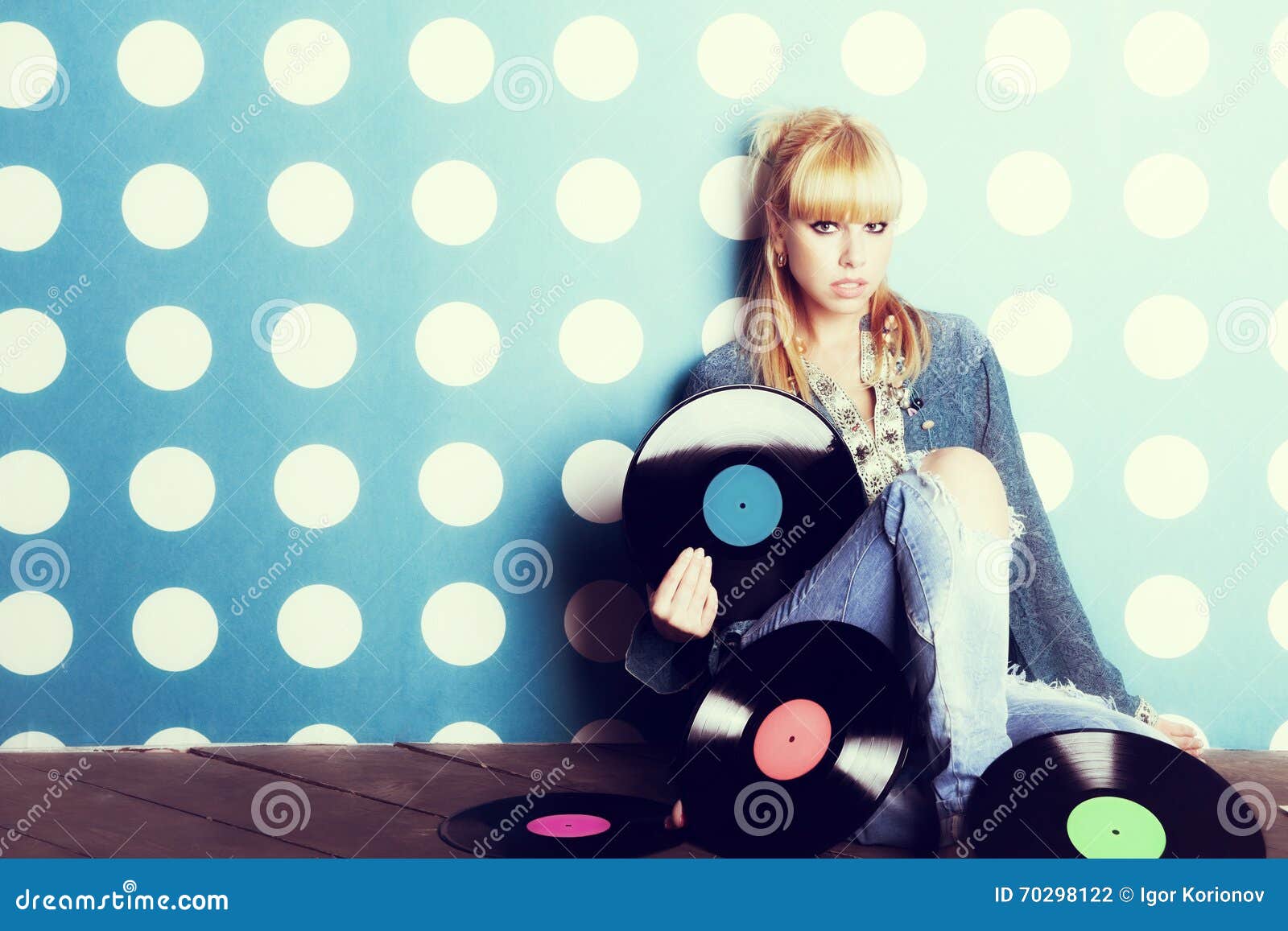 young girl with vinyl records in the hands