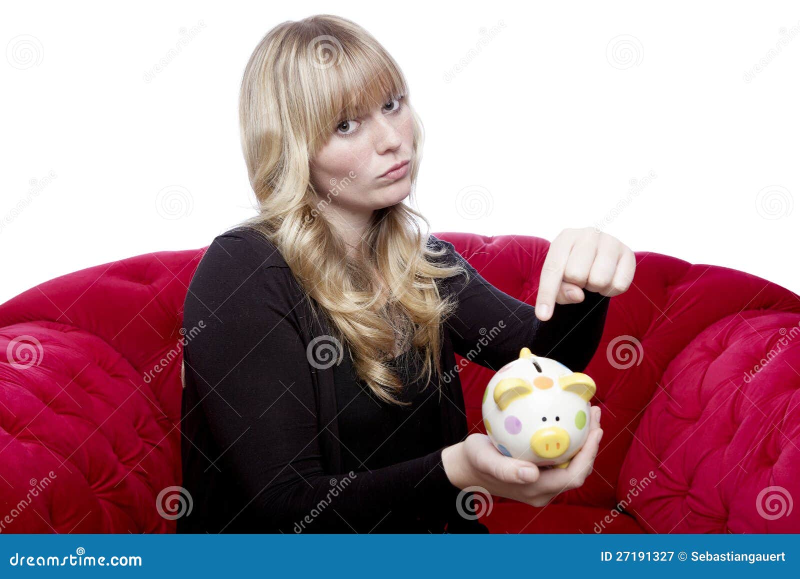 Young girl want money in her piggybank. Young blond haired girl want money in her piggybank on red sofa in front of white background