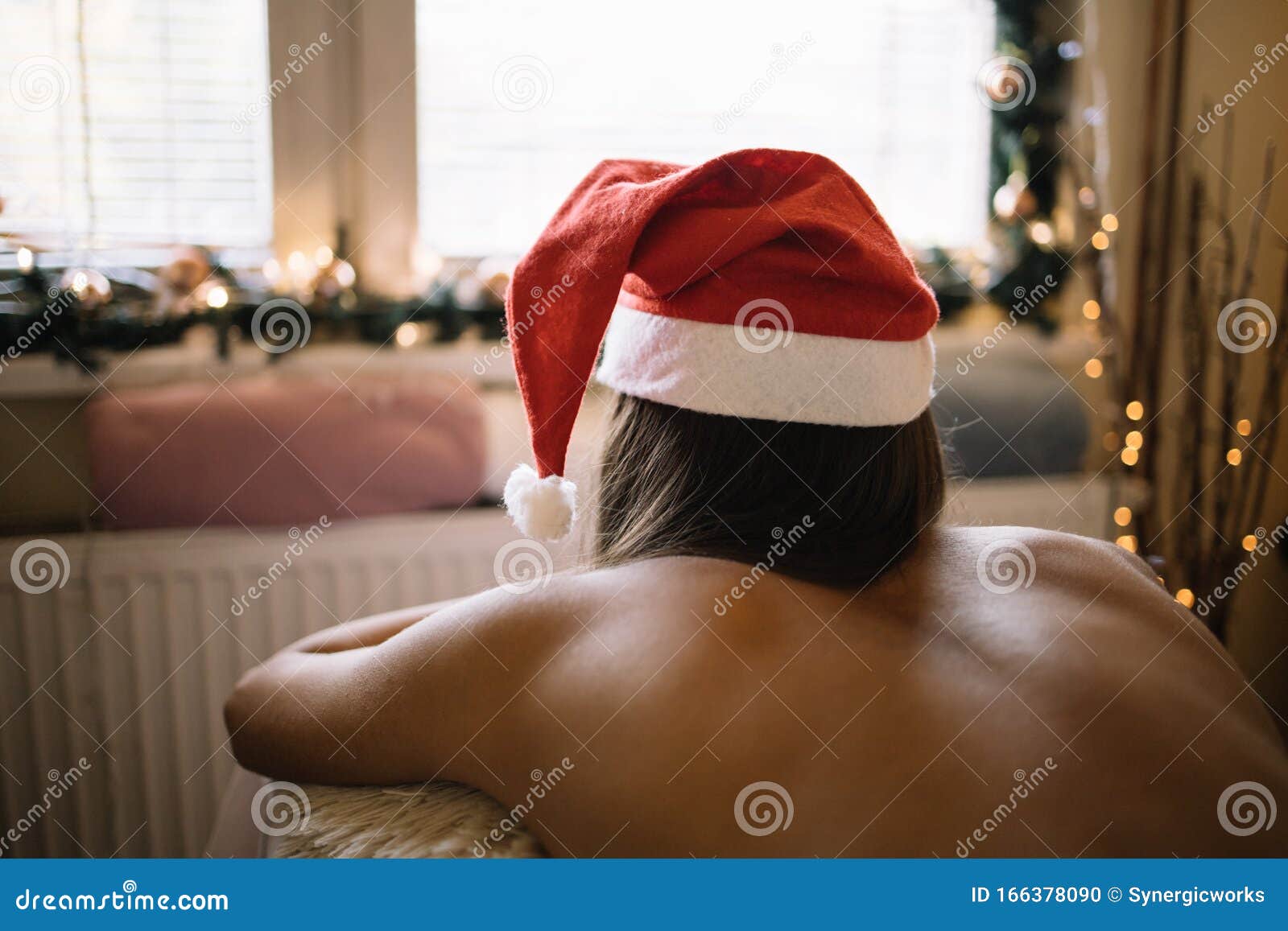 Young Girl Wearing Santa Hat Lying on Massage Table Stock Photo photo