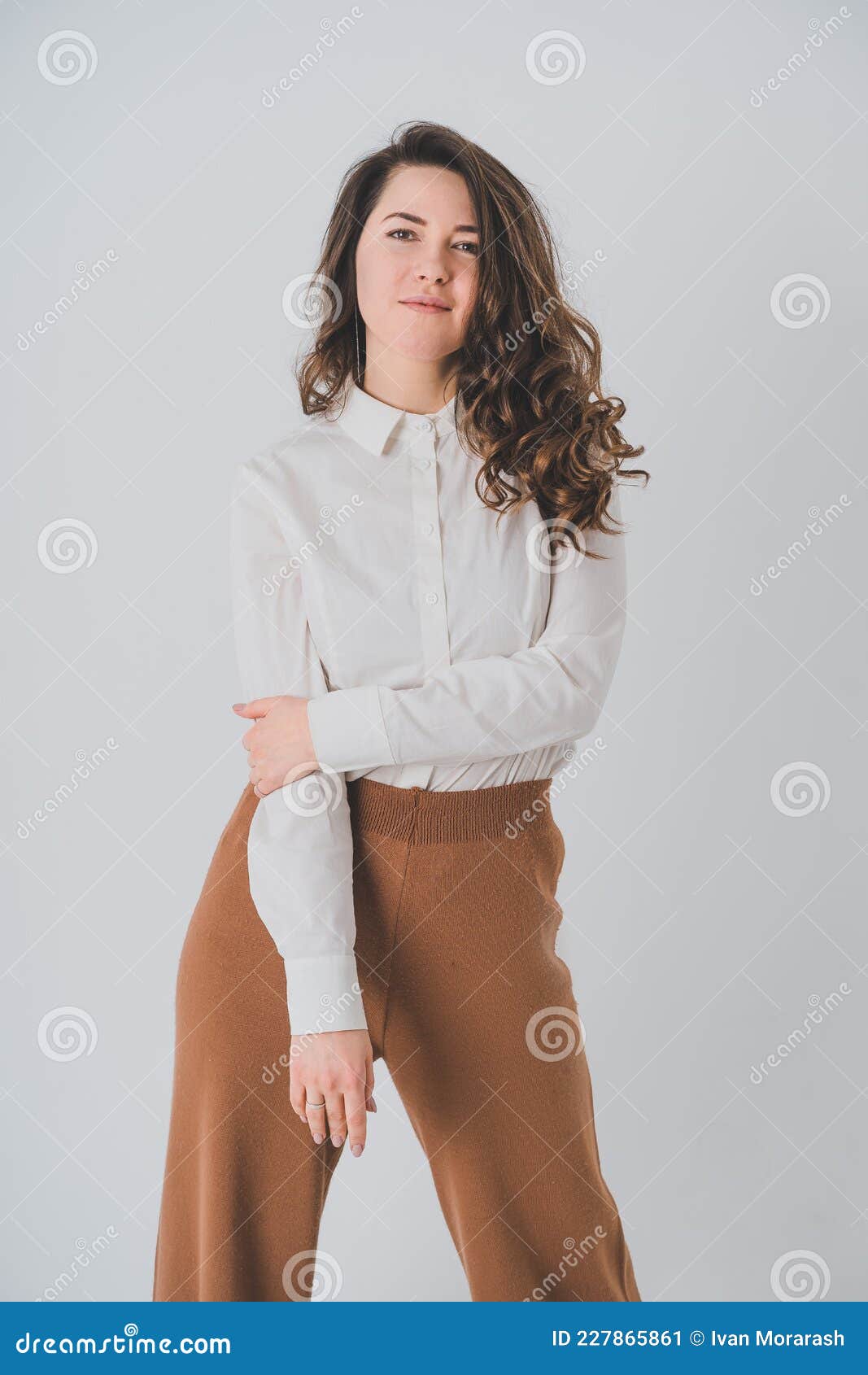 a man in a white shirt and brown pants with suspenders Stock Photo by Icons8