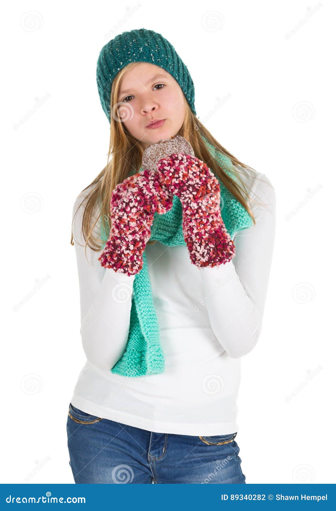 Young Girl with White Shirt, Beanie and Wooly Gloves Eating Gingerbread ...