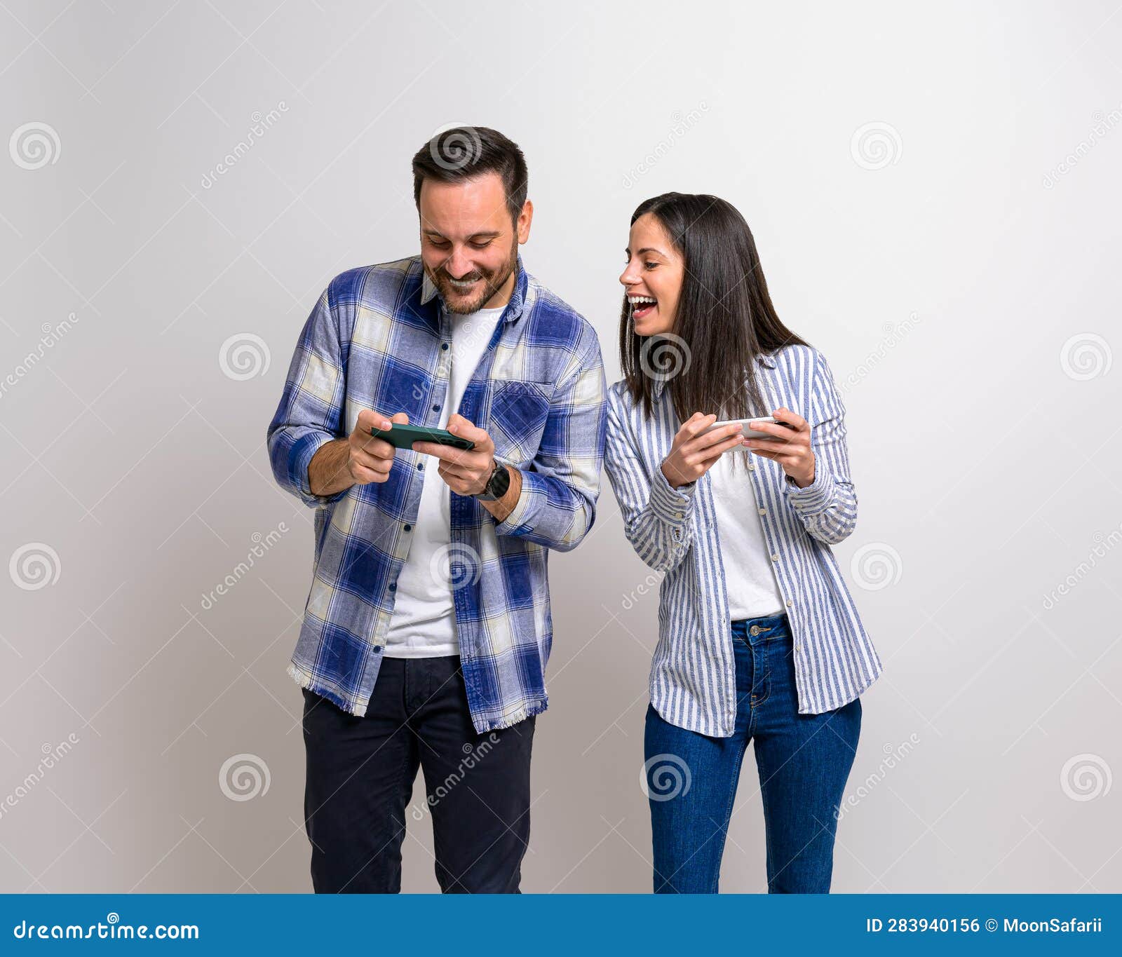 Competitive boyfriend and girlfriend playing video games funny Stock Photo