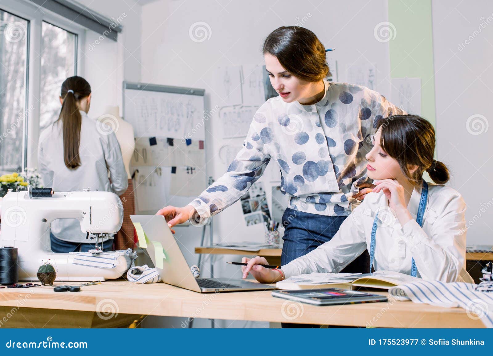 Young Girls Fashion Designers Using Modern Laptop and Drawing Sketches ...