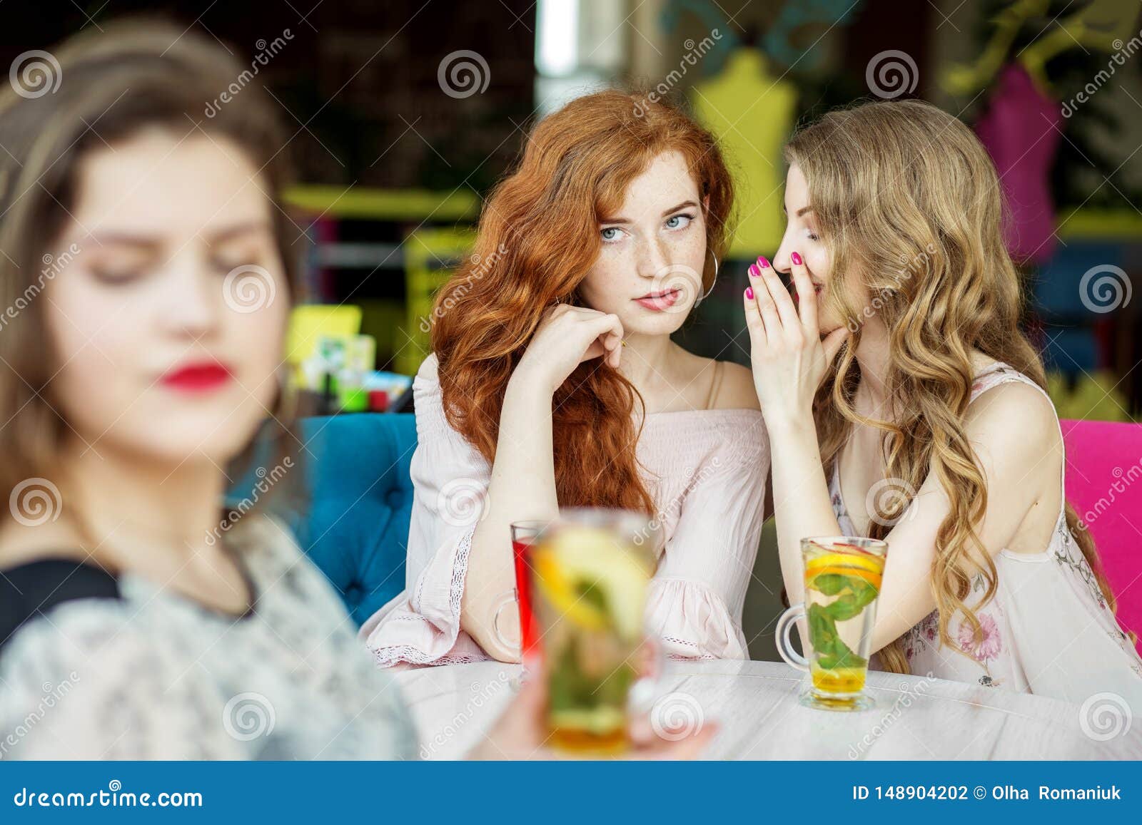 young girls gossip behind the back of a friend. the concept of lifestyle, gossip, lies, friendship