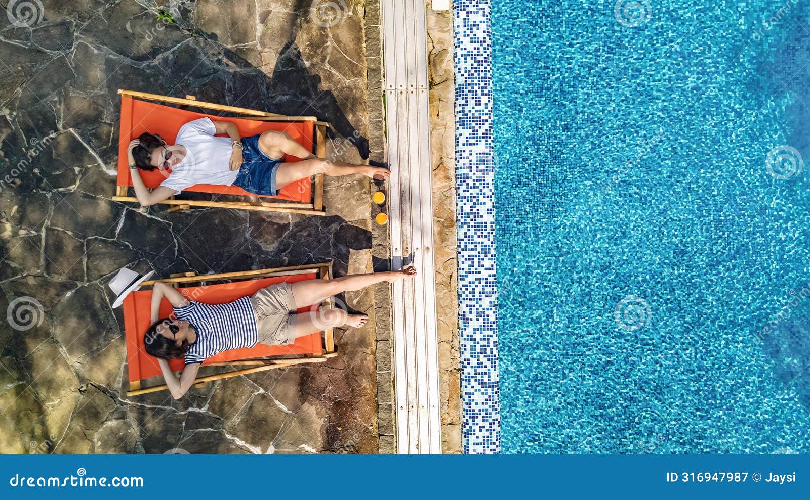 young girls relax near swimming pool in sunbed deckchairs, women friends relax in hotel resort, aerial drone view from above