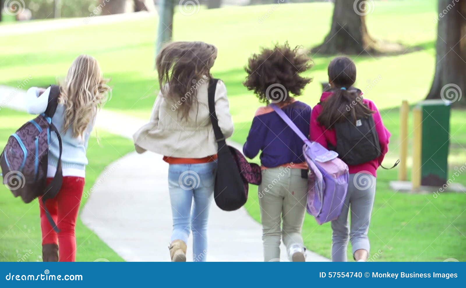 Young Girls Running in Slow Motion Away from Camera in Park Stock