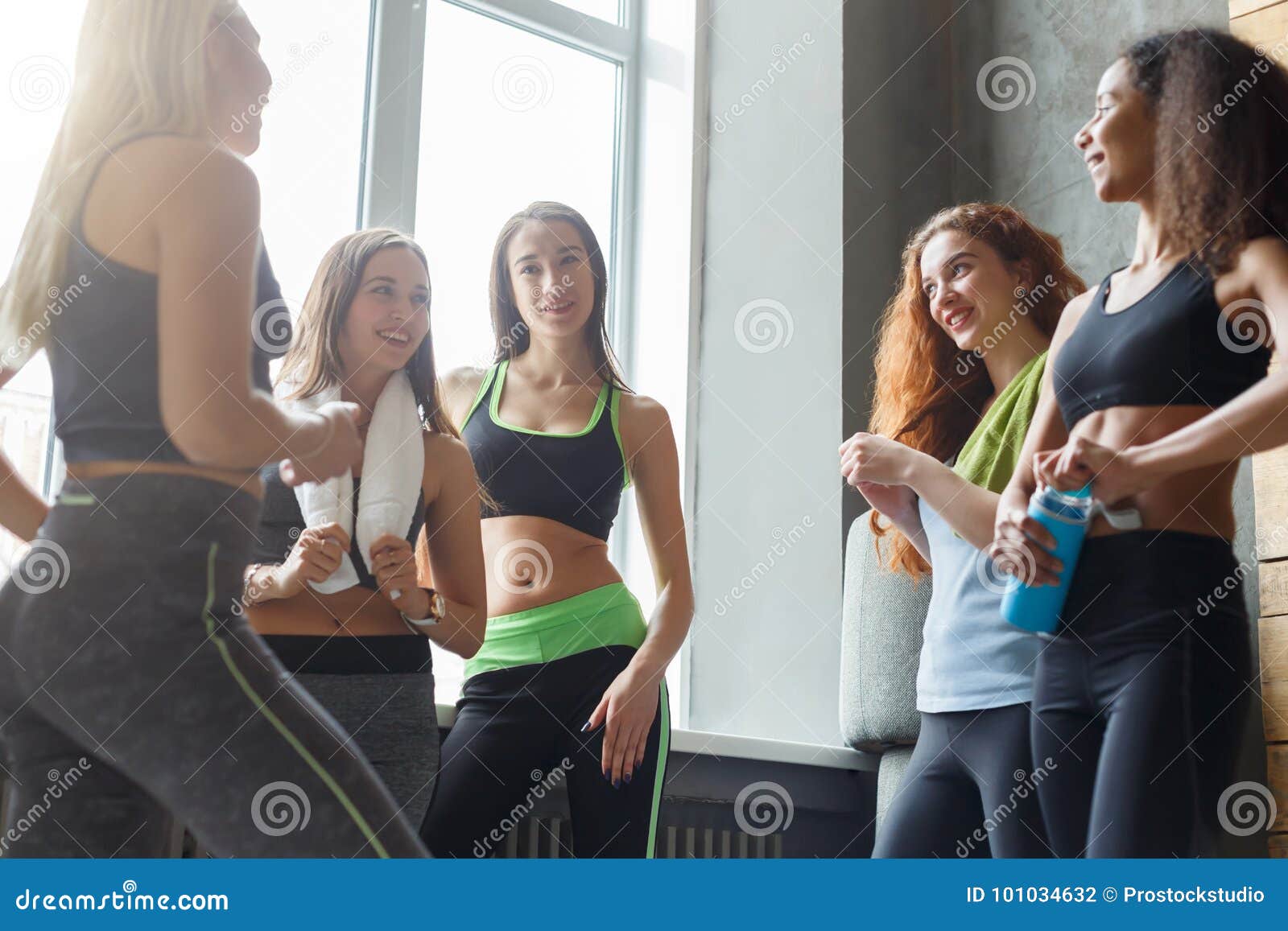 young girls in sportswear chatting before dancing class