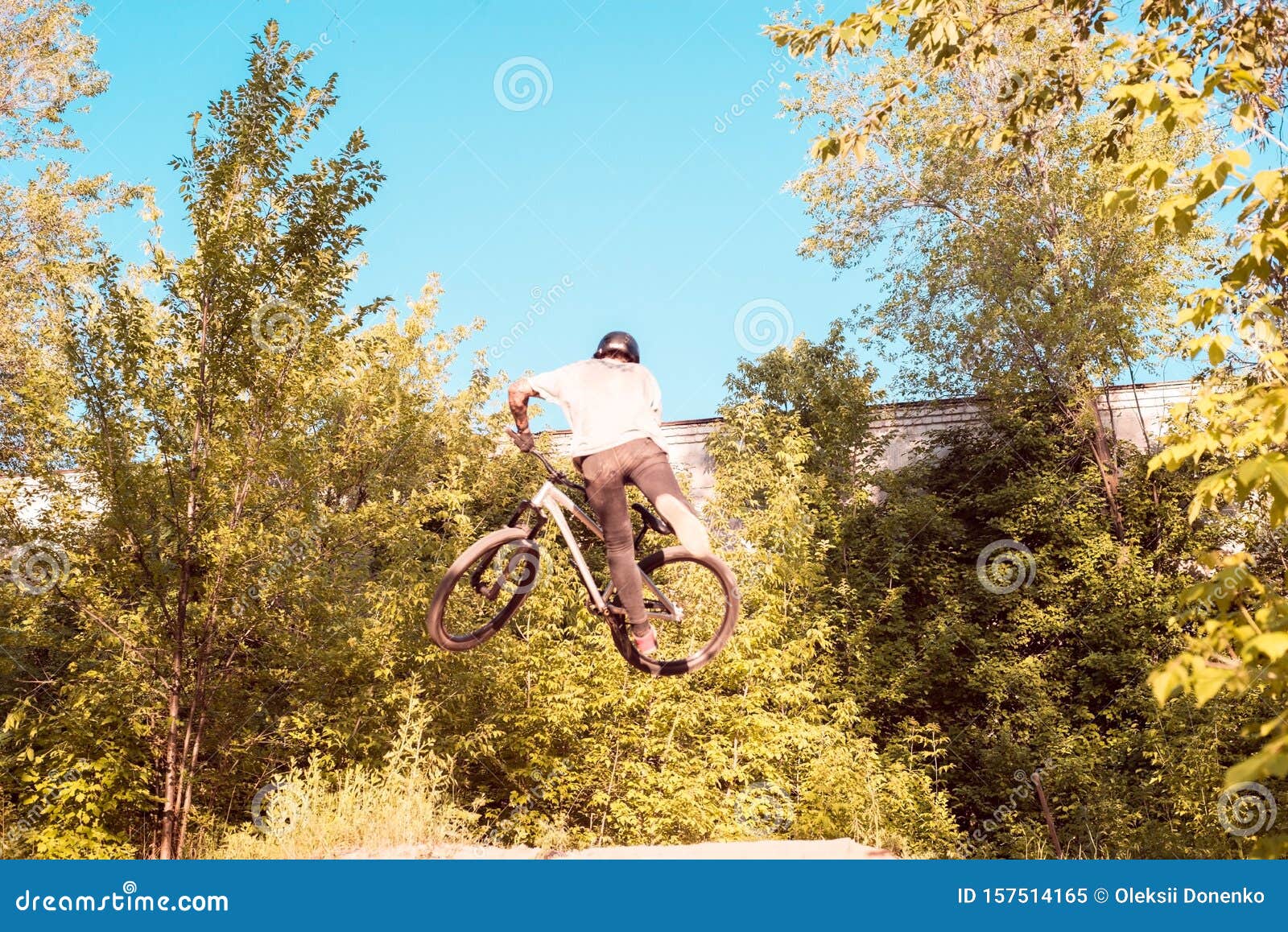A Young Guy, an Athlete, Performs Tricks with a Bike, Jumps on the ...